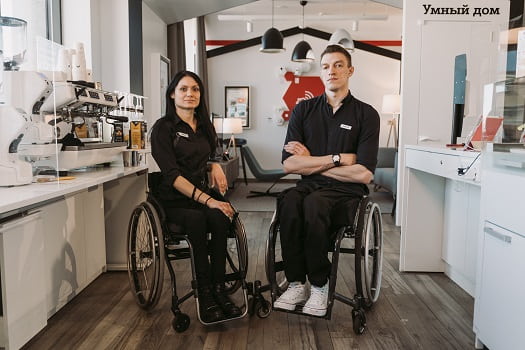 one women and one man in wheelchairs being at their jobs