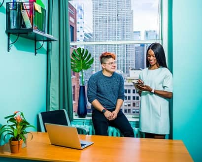 Women talking in office