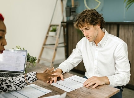 bank teller looking at accounting documents