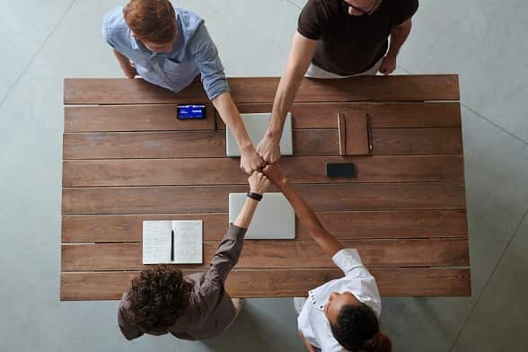 photo of diverse coworkers doing fist bump