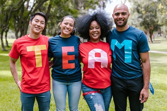 group of people wearing shirts spelled "team"