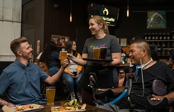 woman serving beer at a bar