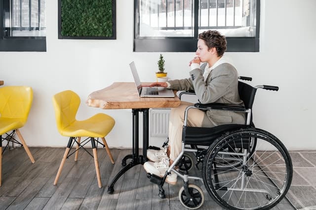 disabled person on wheelchair working behind her desk