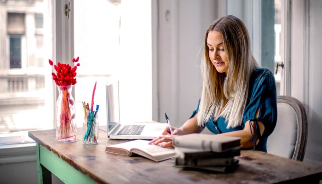 Woman working from home sitting in front of her laptop