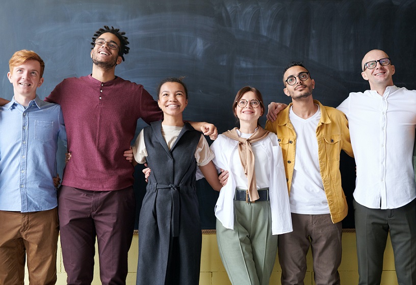 group of workers arm in arm and smilling